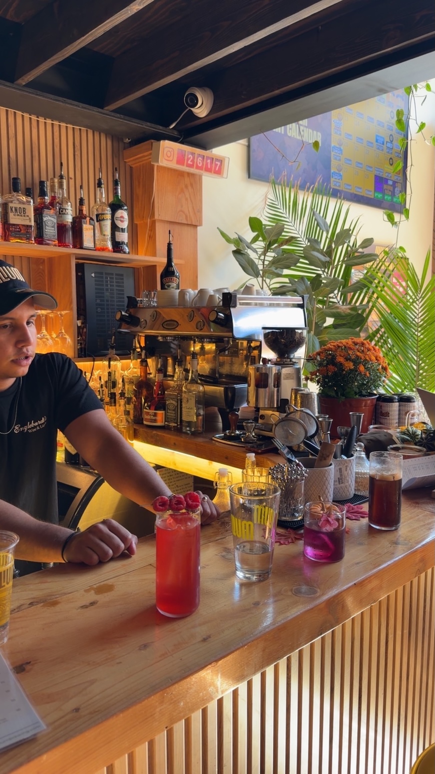 Bartender crafting colorful cocktails at Ilium Bar