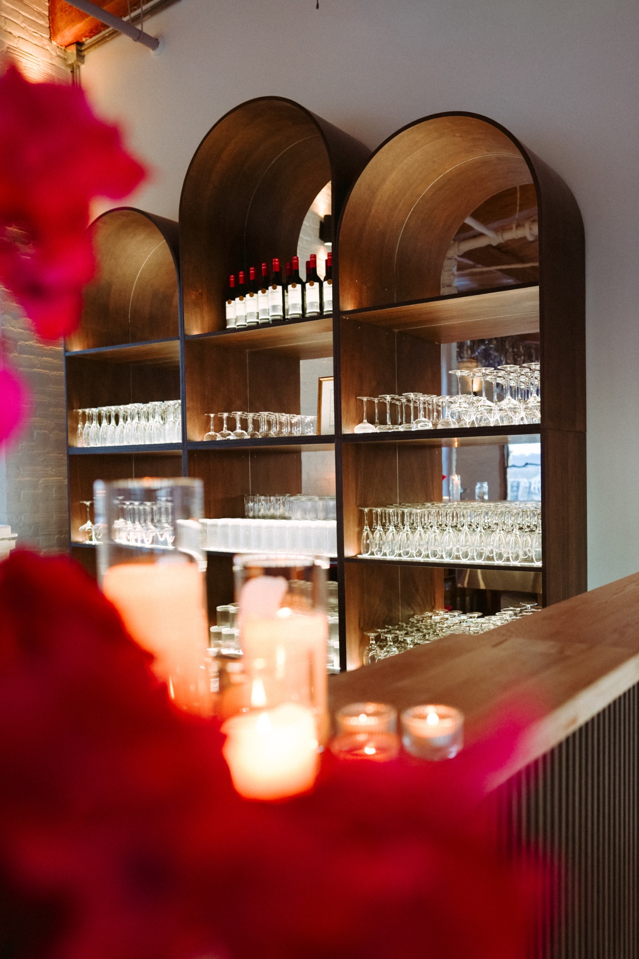 Arched bar shelving with glassware and candles