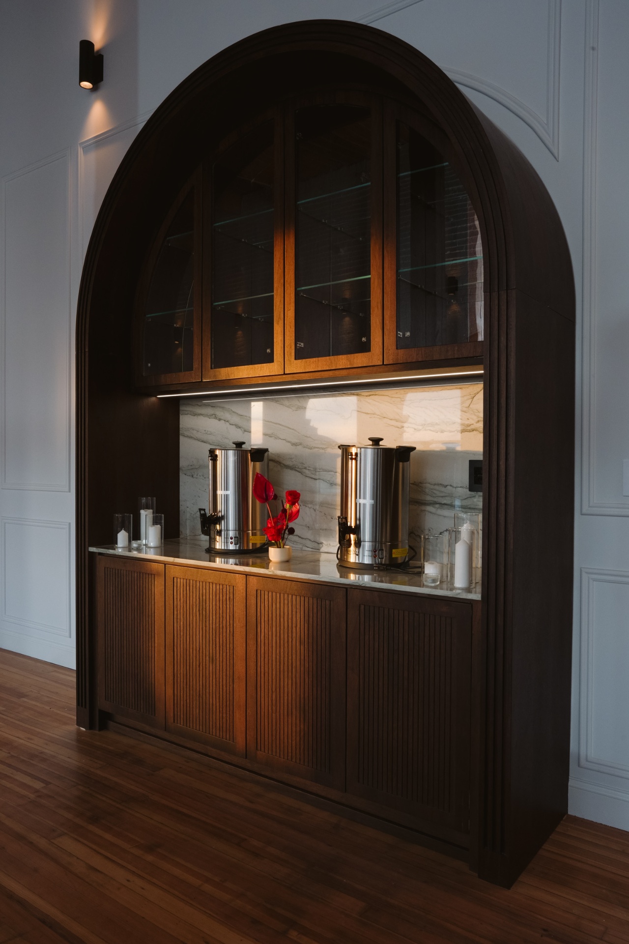 Built-in arched cabinet with marble backsplash